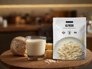 Epicure Alfredo Sauce Mix package with milk and cheese ingredients on a wooden board